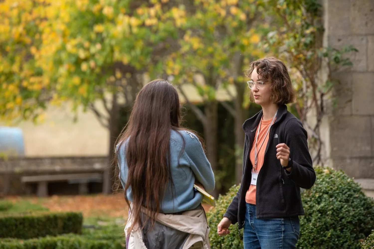 Two attendees talking in a garden