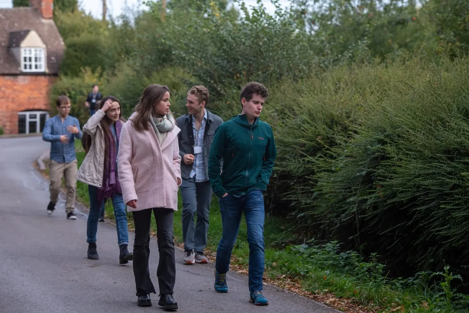 Attendees talking as they walk down a country lane