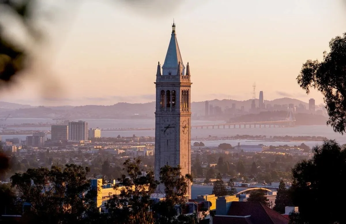 The Berkeley campanile at sunset with the bay behind it