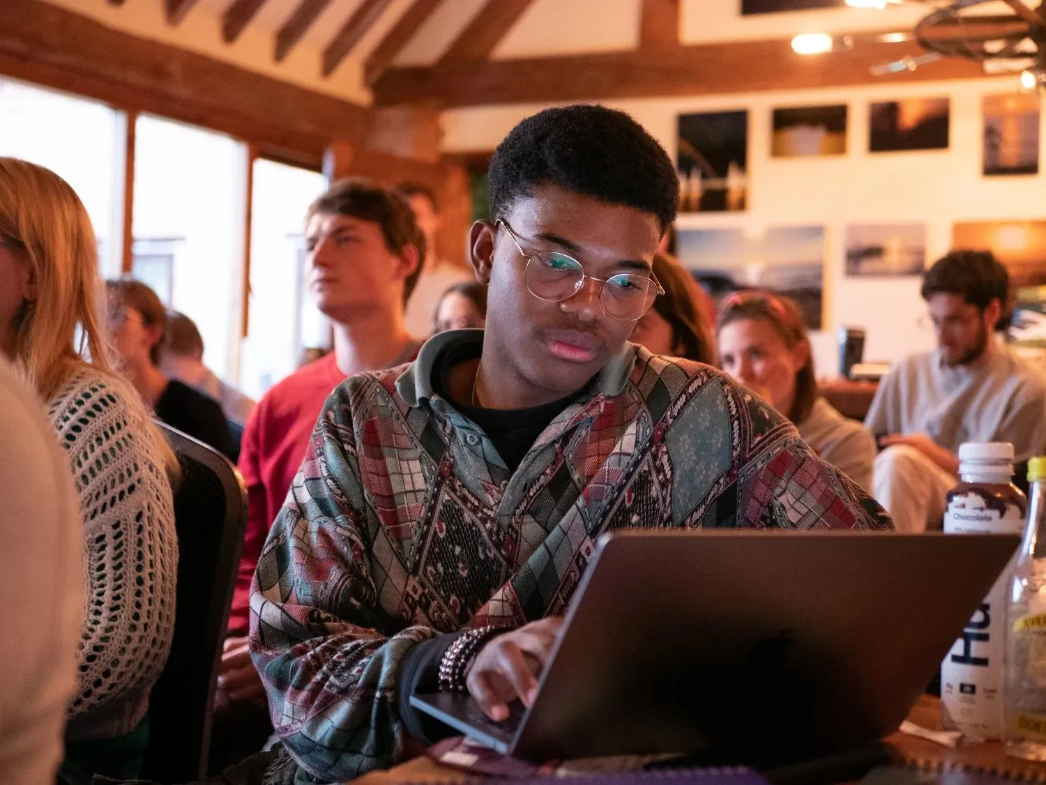 An attendee taking notes on a laptop during a session